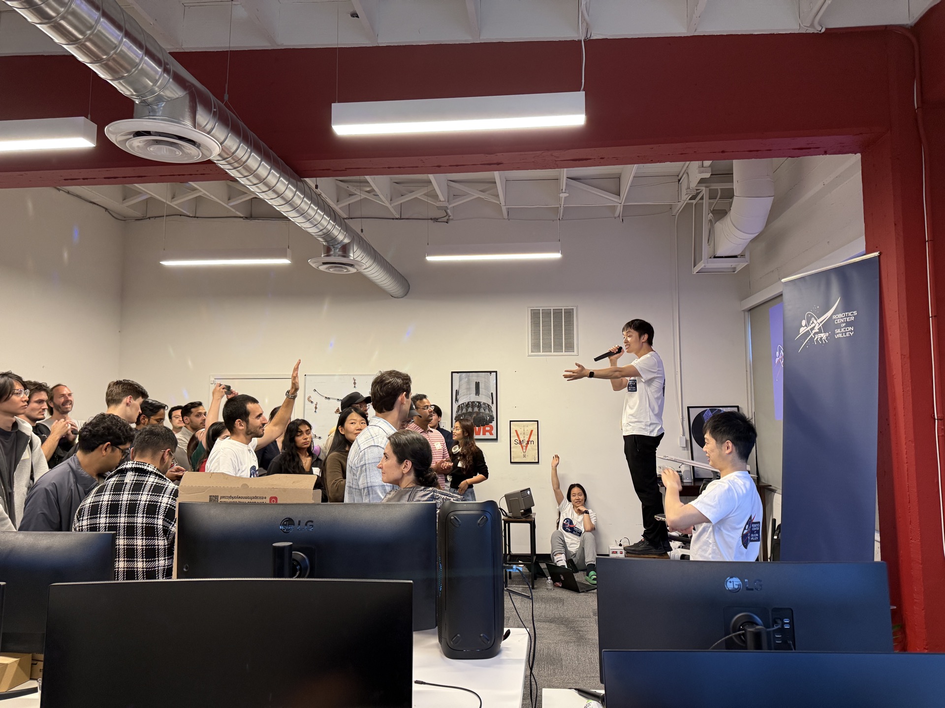 Attendees inspecting robots at a Robotics Center meetup in San Francisco